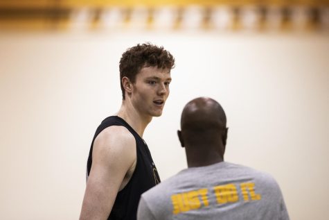 Iowa center Riley Mulvey speaks with assistant coach Courtney Eldridge during an Iowa men’s basketball practice at Carver-Hawkeye Arena on Tuesday, June 21, 2022. 