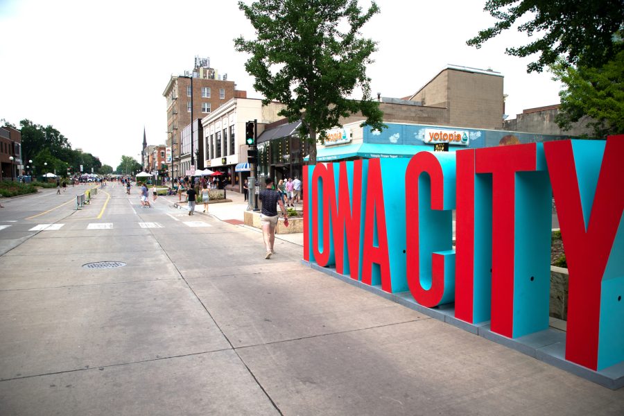 A sign reading “Iowa City” is displayed during the “Downtown Block Party” in Iowa City on Saturday, June 25, 2022.