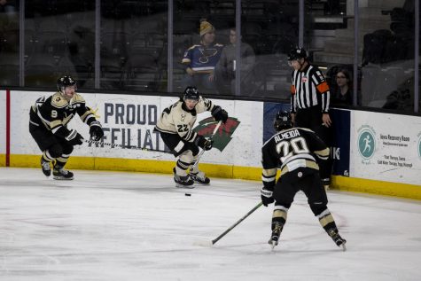 Iowa forward Zach White carries the puck up the ice during a hockey match between Iowa and Wheeling at Xtream Arena in Coralville on Wednesday, April 6, 2022. The Nailers defeated the Heartlanders, 6-4.