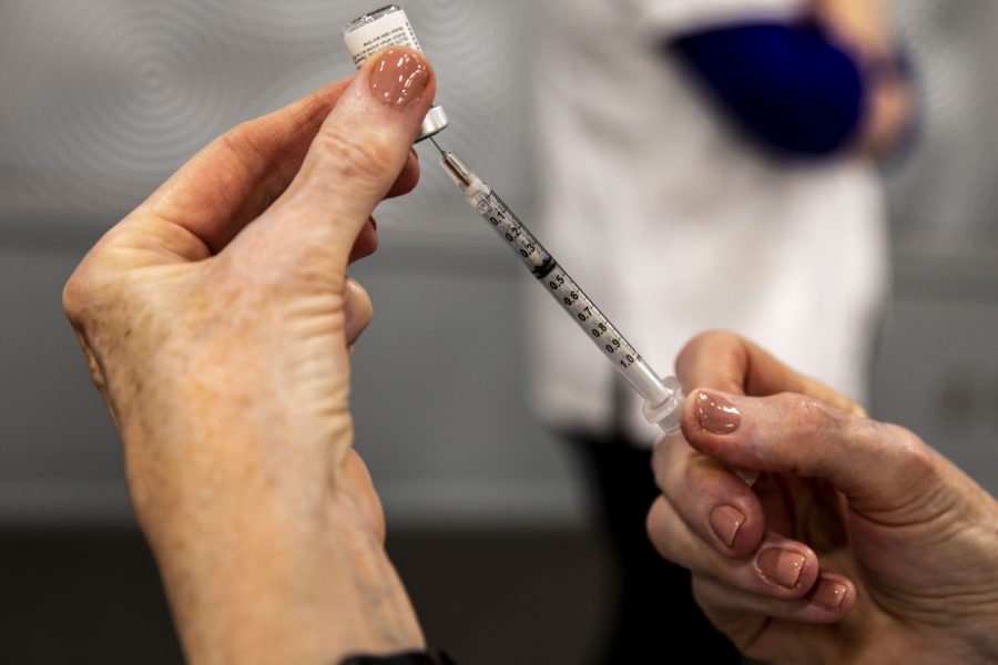 A Pfizer vaccine is drawn up during a vaccination clinic at the Radisson Hotel Conference Center in Coralville on Wednesday, April 14, 2021.