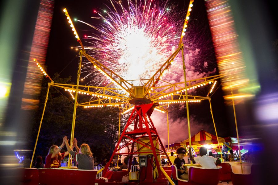 A firework shoots off over a ride at a carnival during “4thFest” at S.T. Morrison Park in Coralville on Monday, July 4, 2022. The carnival featured food, games, and rides.