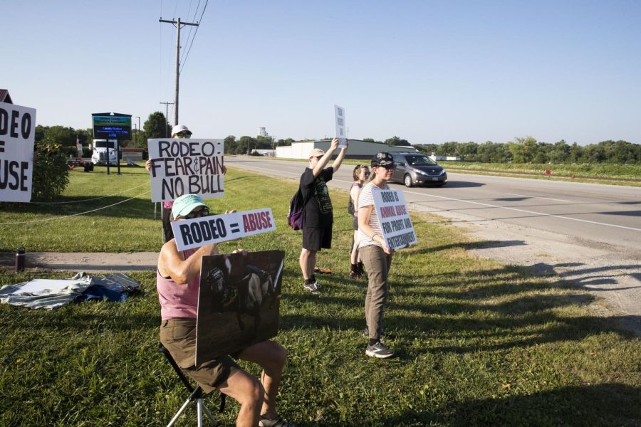 Animal Rights activists stand outside of the Johnson County Fairgrounds during the Sandburr Family Youth Rodeo in Iowa City on Wednesday, July 27, 2022.