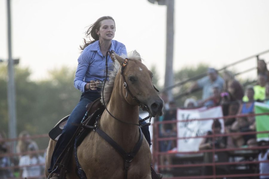 Peyton Schultz rides in the ring during the Sandburr Family Youth Rodeo at the Johnson County Fairgrounds in Iowa City on Wednesday, July 27, 2022.