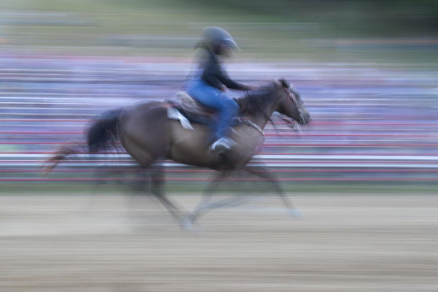 Addison Schultus rides her horse down the ring during the Sandburr Family Youth Rodeo at the Johnson County Fairgrounds  in Iowa City on Wednesday, July 27, 2022.