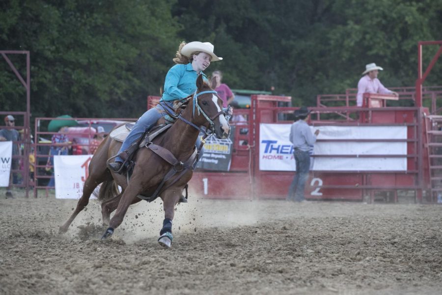 Caitlin Reeves rides her horse in the ring during the Sandburr Family Youth Rodeo at the Johnson County Fairgrounds  in Iowa City on Wednesday, July 27, 2022.