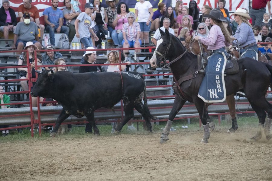 Ranchhands chase after a bull during the Sandburr Family Youth Rodeo at the Johnson County Fairgrounds  in Iowa City on Wednesday, July 27, 2022.