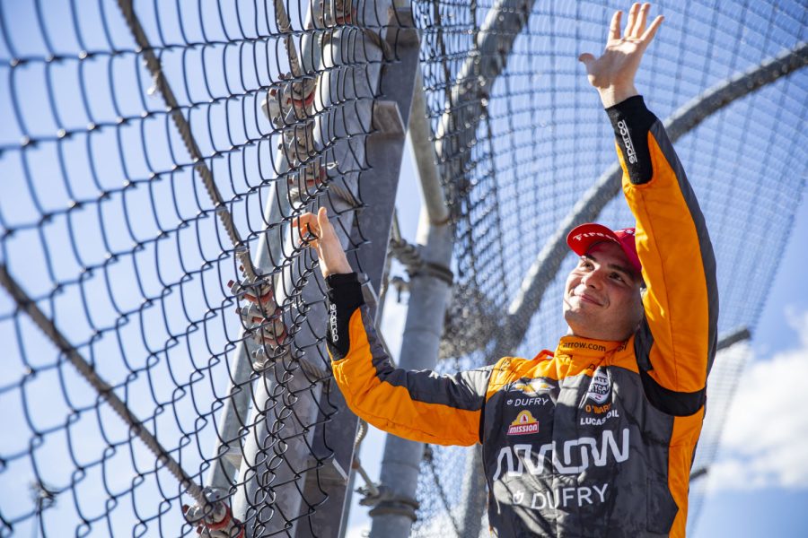 Driver Pato O’Ward (5) climbs the fence after the NTT IndyCar Series Hy-Vee Salute to Farmers 300 presented by Google at Iowa Speedway in Newton, Iowa on Sunday, July 24, 2022. O’Ward finished the race in first place. 