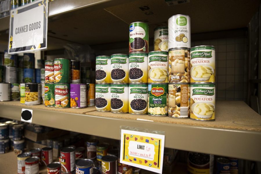 Canned goods sit on a shelf in the food pantry at the Iowa Memorial Union in Iowa City on Sunday, July 10, 2022. A sign enforces a limit on how many cans a pantry user can take. 