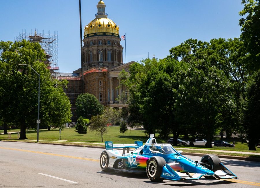 IndyCar driver Josef Newgarden, of the No. 2 Hitachi Chevrolet drive his car down Grand Avenue in Des Moines, Tuesday, June 21, 2022.