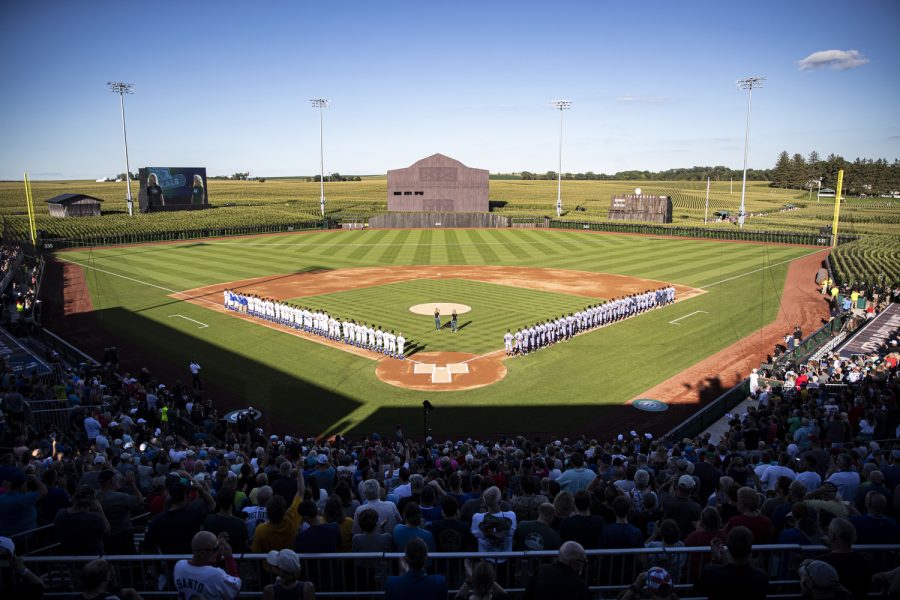 Fans and players observe the national anthem during the Minor League Field of Dreams Game between the Cedar Rapids Kernels, playing as the Bunnies, and the Quad Cities River Bandits, playing as the Blue Sox, in Dyersville, Iowa, on Tuesday, Aug. 9, 2022. The Blue Sox defeated the Bunnies, 7-2.
