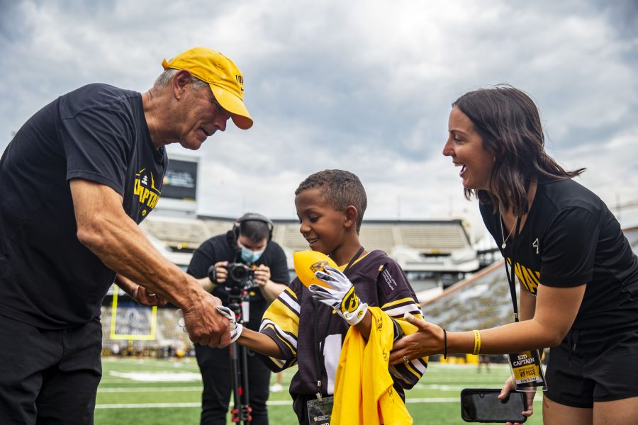Iowa head coach Kirk Ferentz shakes hands with kid captain Eli Belser during Iowa football’s Kids’ Day at Kinnick in Iowa City on Saturday, Aug. 13, 2022. Iowa introduced its 2022 kid captains before the team practiced in front of fans.