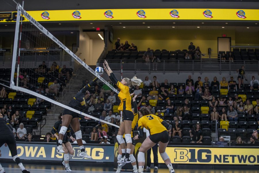Iowa middle hitter Delaney McSweeney blocks the ball from middle hitter Amiya Jones during an Iowa women’s volleyball media conference and scrimmage at Xtream Arena in Coralville on Saturday, Aug. 20, 2022.