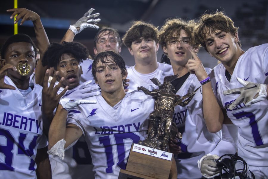 Liberty poses with the Tightens trophy during a football game between City High and Liberty at Kinnick Stadium in Iowa City on Friday, Aug. 26, 2022. Liberty defeated City High 36-19.