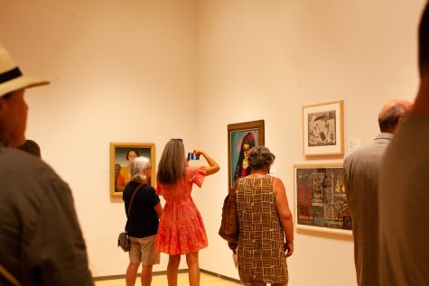 People take photos of exhibits in the Stanley Museum of Art at its opening celebration at the University of Iowa on Friday, Aug. 26, 2022.