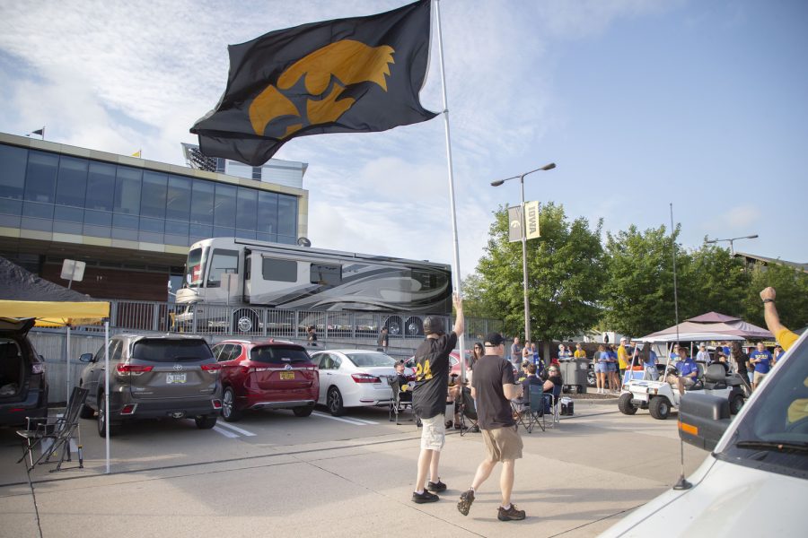 A Iowa fan holds up a Hawkeye Flag before a football game between Iowa and South Dakota State on Saturday, Sept. 3, 2022.
