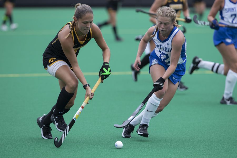 Iowa midfielder Esme Gibson and St.Louis midfielder Lauren Pendergast chase the ball during a field hockey game between Iowa and St. Louis at Grant Field in Iowa City on Sunday, Sept.4, 2022. The Hawkeyes defeated the Billikens, 6-0. Gibson recorded two assists.