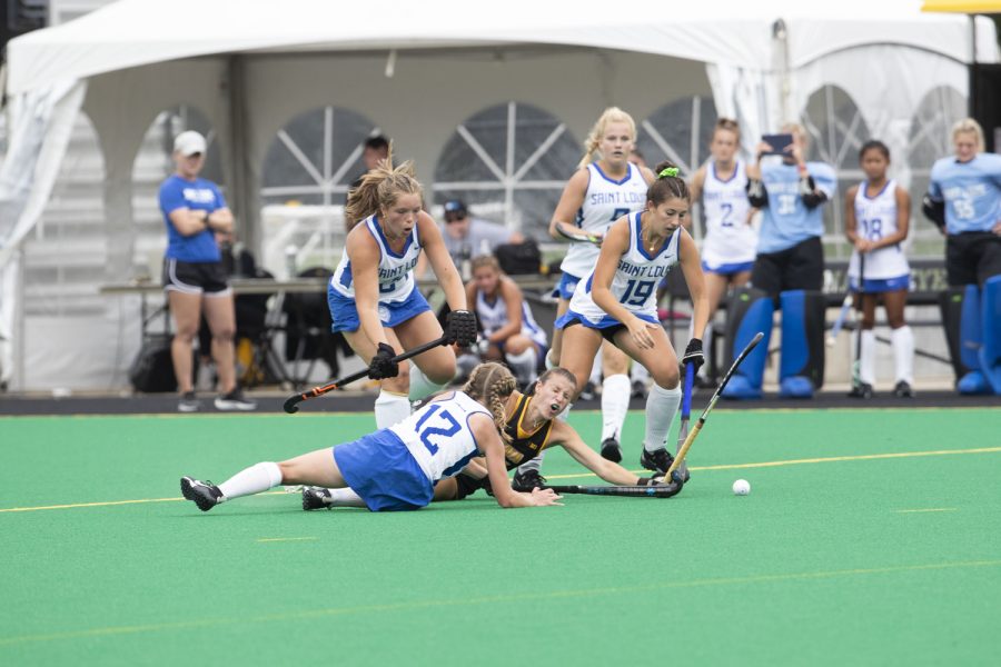 Iowa midfielder Esme Gibson and St.Louis players battle for the ball during a field hockey game between Iowa and St. Louis at Grant Field in Iowa City on Sunday, Sept.4, 2022. The Hawkeyes defeated the Billikens, 6-0. Gibson recorded two assists.