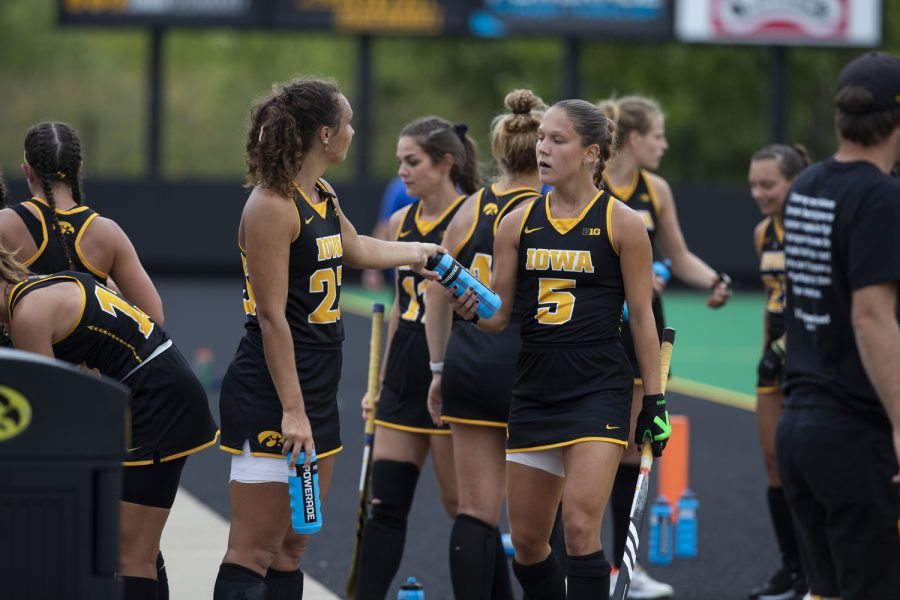 Iowa defender Harper Dune hands a water bottle to teammate Olivia Frazier after a field hockey game against St. Louis at Grant Field in Iowa City on Sunday, Sept.4, 2022. The Hawkeyes defeated the Billikens, 6-0.