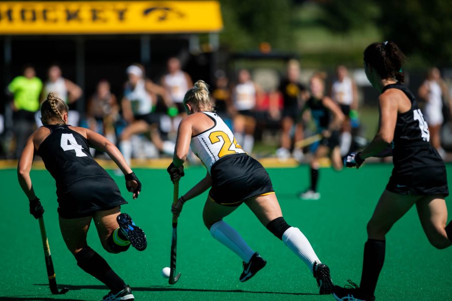 Iowa forward Annika Herbine protects the ball as Providence midfielder Lisa McNamara comes in from the left during a field hockey game between Iowa and Providence at Grant Field in Iowa City on Sunday, Sept. 9, 2022. The Hawkeyes defeated the Friars, 3-1.
