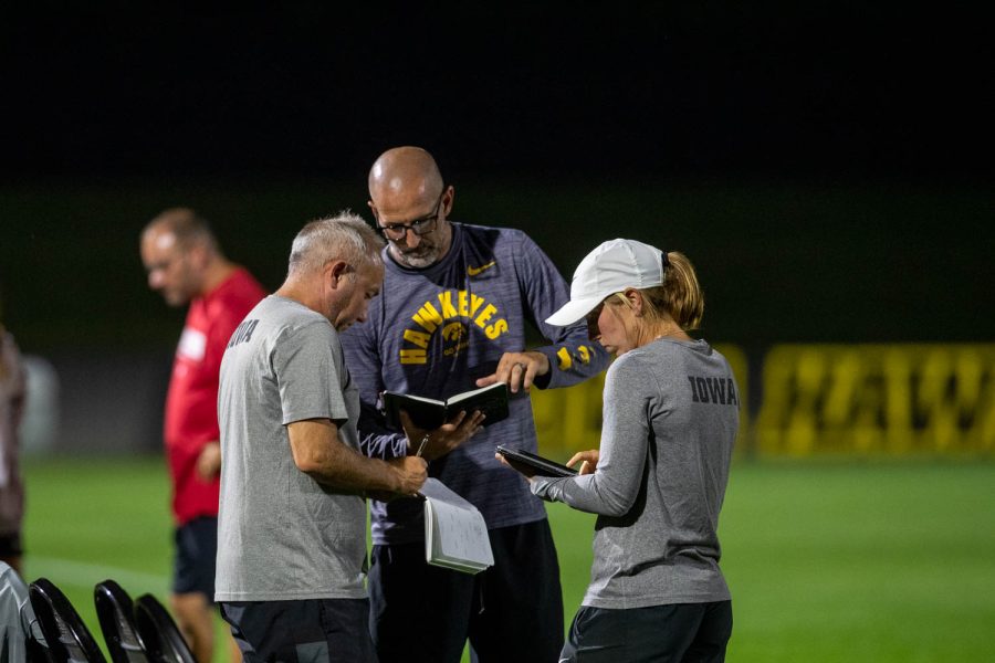 Iowa head coach Dave DiIanni talks with other officials during a soccer game between Iowa and Wisconsin at the University of Iowa Soccer Complex in Iowa City on Friday, Sept. 16, 2022. The Badgers defeated the Hawkeyes 4-1. 
