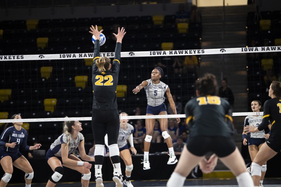 North+Florida+outside+hitter+Mahalia+White+spikes+the+ball+while+Iowa+outside+hitter+Addie+VanderWeide+blocks+the+ball++during+a+volleyball+match+between+Iowa+and+North+Florida+at+Xtream+Arena+in+Coralville+on+Friday%2C+Sept.+16%2C+2022.+The+Hawkeyes+defeated+the+Ospreys+3-0.