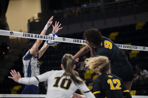 Florida middle blocker Maddie Boyd jumps up to block Iowa middle hitter Amiya Jones spike during a volleyball game between Iowa and North Florida at Xtream Arena in Coralville on Friday, Sept. 16, 2022. Boyd had three blocks. The Hawkeyes defeated the Ospreys 3-0.