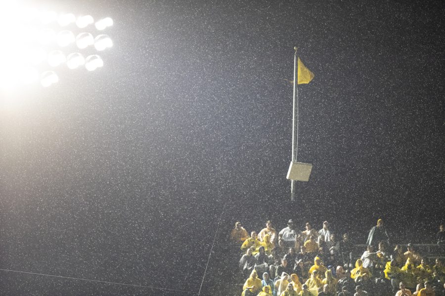 Iowa fans observe action while rain falls down during a football game between Iowa and Nevada at Kinnick Stadium in Iowa City on Saturday, Sept. 17, 2022.