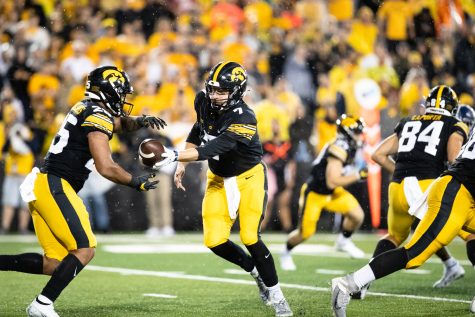 Iowa quarterback Spencer Petras hands the ball off to running back Gavin Williams during a football game between Iowa and Nevada at Kinnick Stadium in Iowa City on Saturday, Sept. 17, 2022. Williams rushed for 57 yards on 16 carries. The Hawkeyes defeated the Wolf Pack, 27-0.
