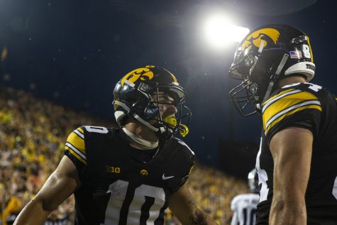 Iowa wide receiver Arland Bruce IV celebrates his touchdown reception with tight end Sam LaPorta during a football game between Iowa and Nevada at Kinnick Stadium in Iowa City on Saturday, Sept. 17, 2022. Bruce IV caught three passes for 50 yards and a touchdown. The Hawkeyes defeated the Wolf Pack, 20-7.