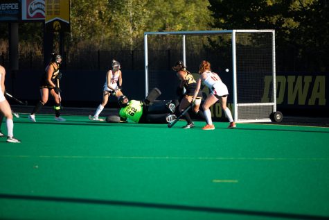 Marylands Dani Van Rootselaar scores a goal, pushing the ball past Iowa goaltender Grace McGuire on Friday, Sept. 30, 2022. The No. 4 Terrapins defeated the No. 3 Hawkeyes, 2-1, in overtime at Grant Field in Iowa City.  