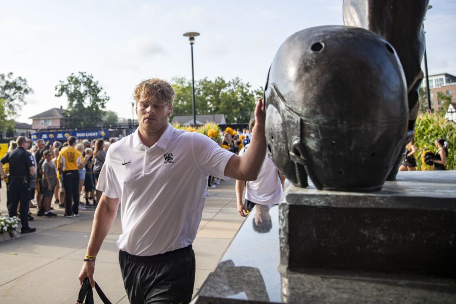 Iowa punter Tory Taylor touches the Nile Kinnick statue during the Hawk Walk before a football game between Iowa and South Dakota at Kinnick Stadium on Saturday, Sept. 3, 2022. The Hawkeyes defeated the Jackrabbits, 7-3.