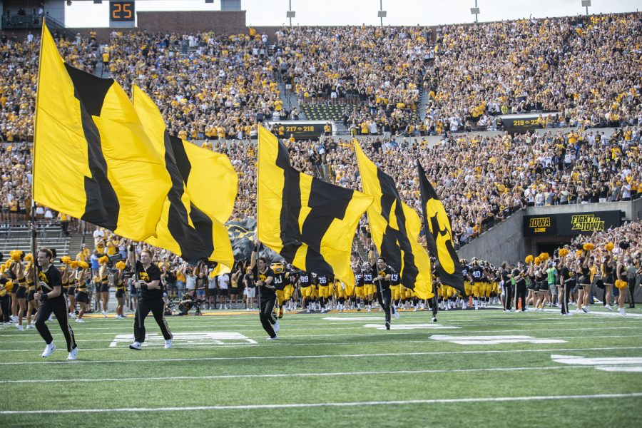 Cheerleaders fly flags before a football game between Iowa and South Dakota State at Kinnick Stadium on Saturday, Sept. 3, 2022. The Hawkeyes defeated the Jackrabbits, 7-3.
