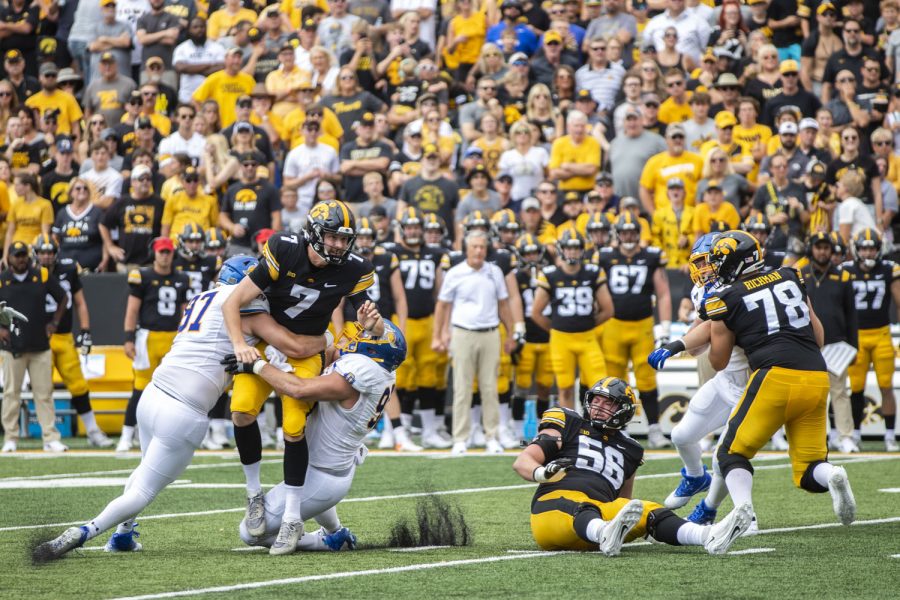 Iowa quarterback is sacked Spencer Petras by South Dakota State defensive end Reece Winkelman during a football game between Iowa and South Dakota at Kinnick Stadium on Saturday, Sept. 3, 2022. The Hawkeyes defeated the Jackrabbits 7-3. Petras threw an average of 4.4 yards.