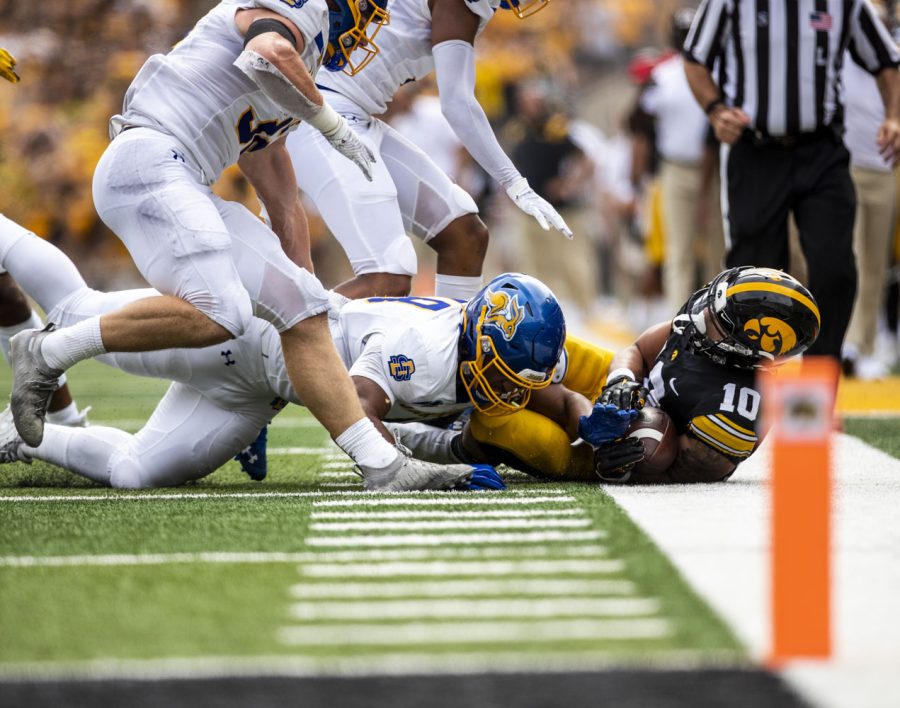 Iowa Arland Bruce IV is tackled during a football game between Iowa and South Dakota at Kinnick Stadium on Saturday, Sept. 3, 2022. The Hawkeyes defeated the Jackrabbits 7-3. Bruce had one carry for 11 yards.