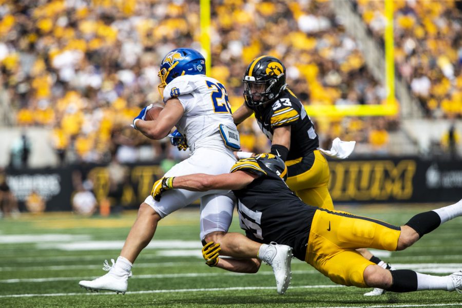 South Dakota State running back Isiah Davis carries the ball while Iowa defensive back Riley Moss and line backer Jack Campbell lunge to tackle Davis during a football game between Iowa and South Dakota at Kinnick Stadium on Saturday, Sept. 3, 2022. The Hawkeyes defeated the Jackrabbits 7-3. Davis ran for 50 yards.