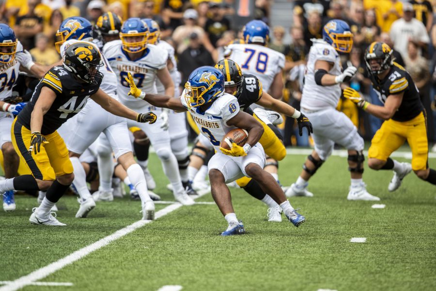 South Dakota State running back Amar Johnson holds the ball as Iowa linebacker Seth Benson attempts take (3) down during a football game between Iowa and South Dakota at Kinnick Stadium on Saturday, Sept. 3, 2022. The Hawkeyes defeated the Jackrabbits 7-3. Johnson ran for three yards.