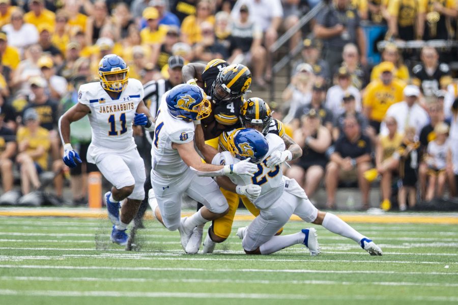 A group of South Dakota State defenders tackle Iowa running back Leshon Williams during a football game between Iowa and South Dakota State at Kinnick Stadium on Saturday, Sept. 3, 2022. The score at halftime was tied, 3-3.