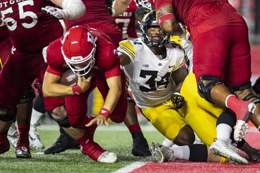 Rutgers quarterback Evan Simon lunges away from Iowa linebacker Jay Higgins to avoid a safety during a football game between Iowa and Rutgers at SHI Stadium in Piscataway, N.J., on Saturday, Sept. 24, 2022. The Hawkeyes defeated the Scarlet Knights, 27-10. Higgins had five total tackles.