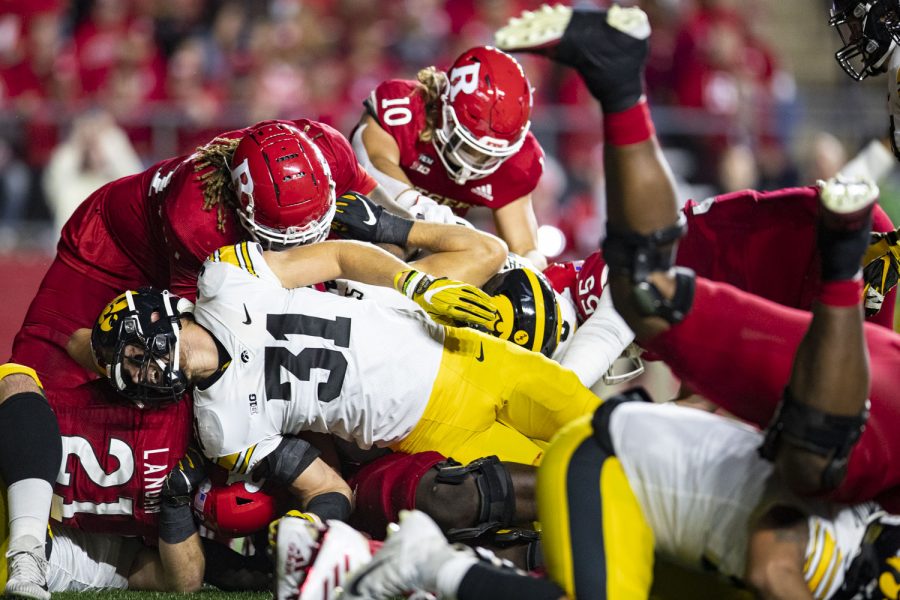 Rutgers tight end Johnny Langan dives forward as Iowa linebacker Jack Campbell and company attempt to push him back during a football game between Iowa and Rutgers at SHI Stadium in Piscataway, N.J. on Saturday, Sept. 24, 2022. The Hawkeyes lead the Rutgers 17-3 at halftime. 