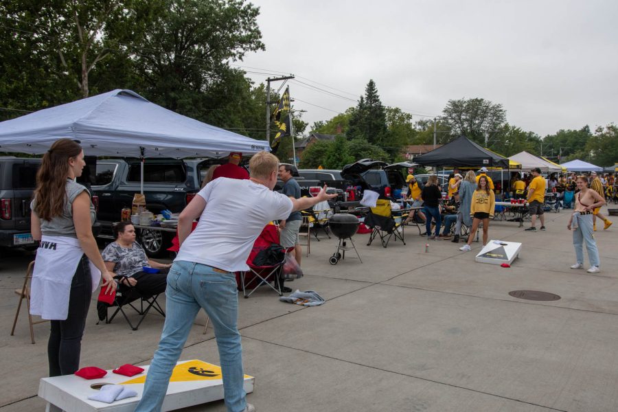Fans play bags at a tailgating lot in Iowa City, Iowa, on Saturday, Sept. 10, 2022 for the Iowa vs. Iowa State football game.