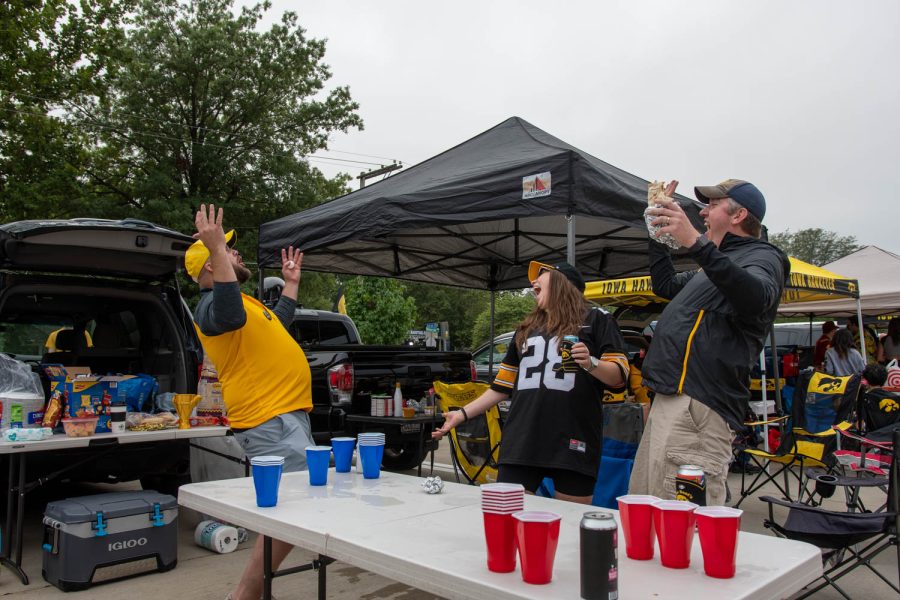 Fans celebrate during a game of pong at a tailgating lot in Iowa City, Iowa, on Saturday, Sept. 10, 2022 for the Iowa vs. Iowa State football game.