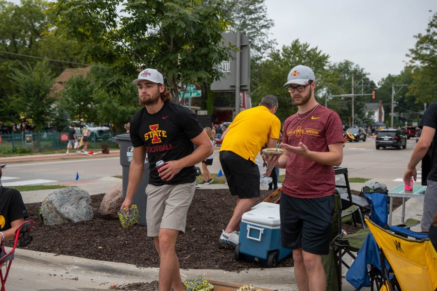Iowa State fans play bags at a tailgating lot in Iowa City, Iowa, on Saturday, Sept. 10, 2022 for the Iowa vs. Iowa State football game.