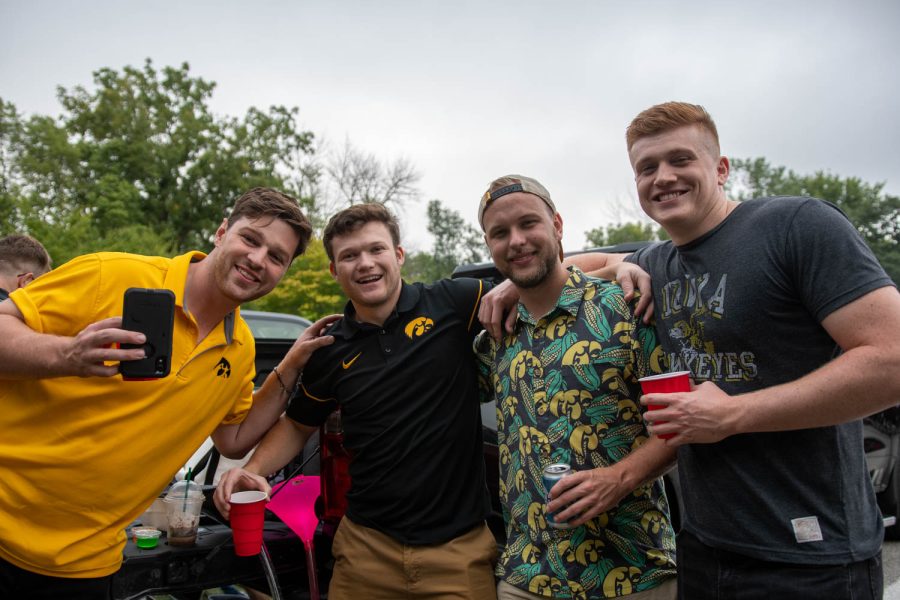 Hawkeye fans pose for a photo at a tailgating lot in Iowa City, Iowa, on Saturday, Sept. 10, 2022, for the Iowa vs. Iowa State football game.