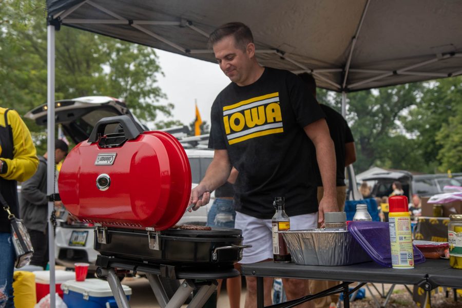 Hawkeye fan Michael Lefever grills burgers at a tailgating lot in Iowa City, Iowa, on Saturday, Sept. 10, 2022 for the Iowa vs. Iowa State football game.