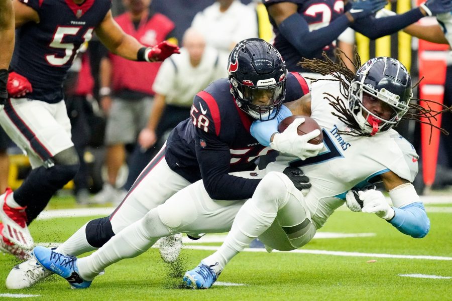 Tennessee Titans running back D'onta Foreman gets stopped by Houston Texans middle linebacker Christian Kirksey during the first quarter at NRG Stadium on Jan. 9, 2022. 
