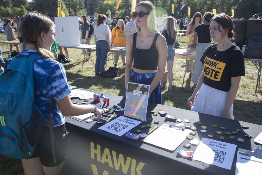 Hawk+the+Vote+volunteers+Mackenzie+Northup+and+Alexis+Carfrae+talk+to+a+student++during+the+Student+Engagement+Fair+at+Hubbard+Park+in+Iowa+City+on+August+31%2C+2022.