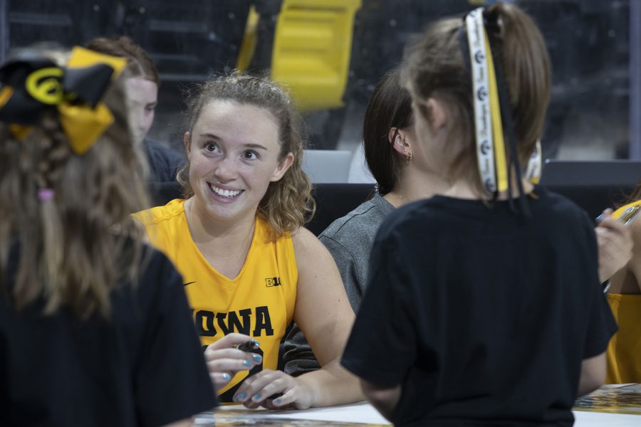 Number+12+Bailey+Ortega+of+the+Iowa+volleyball+team+signing+an+Iowa+volleyball+poster+for+a+fan+following+the+Iowa+vs.+Purdue+match+at+Xtreme+Arena+in+Coralville+on+Sept.+25%2C+2022.+