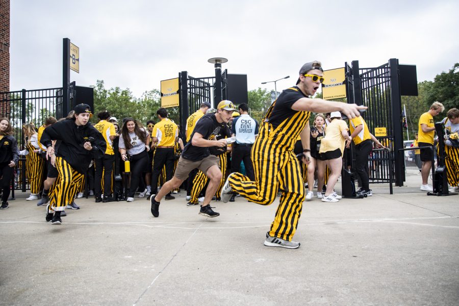 Members of the Iowa student section run to their seats before a football game between Iowa and Iowa State at Kinnick Stadium in Iowa City on Saturday, Sept. 10, 2022.