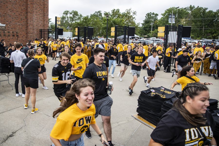 Members of the Iowa student section run to their seats before a football game between Iowa and Iowa State at Kinnick Stadium in Iowa City on Saturday, Sept. 10, 2022.