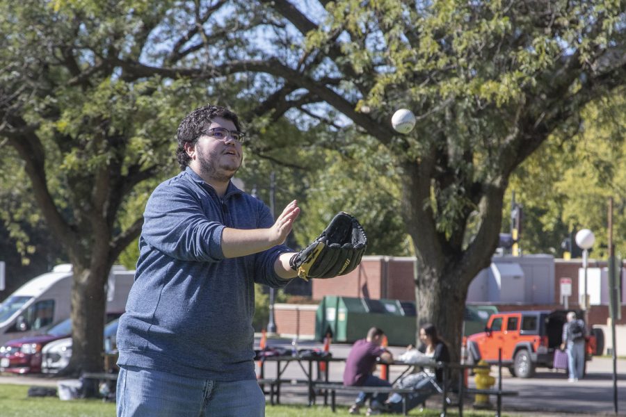 Daily Iowan Reporter Alejandro Rojas catches a ball from Rod Sullivan during a game of catch in Hubbard Park on Wednesday, Sept. 28, 2022.